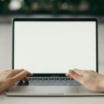 photo of person s hands using laptop